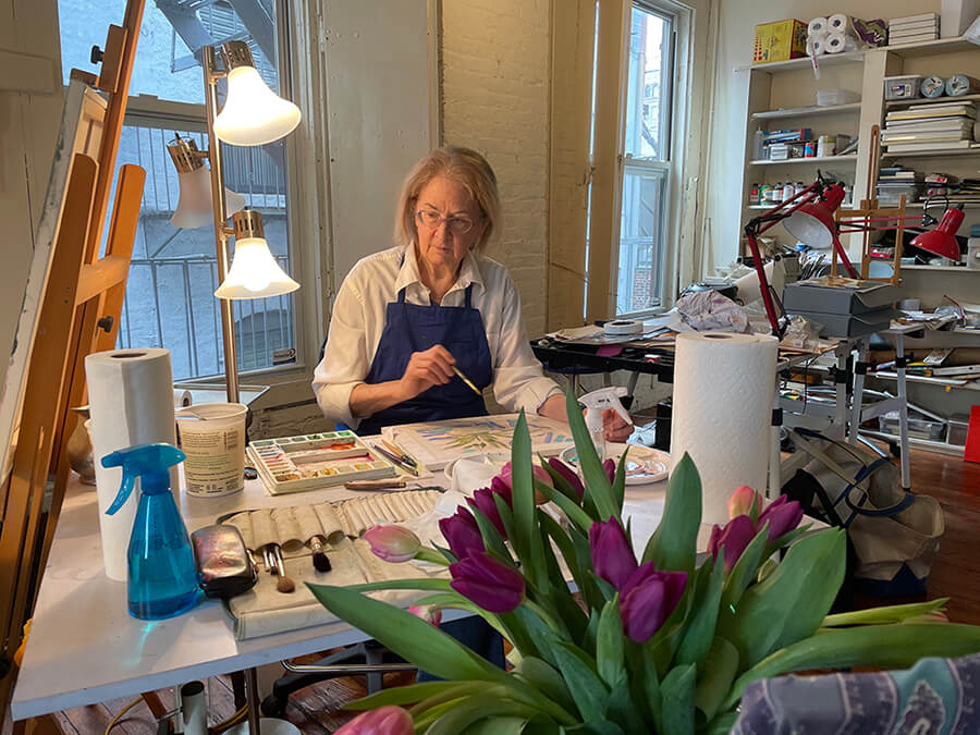 Annie painting at her desk
